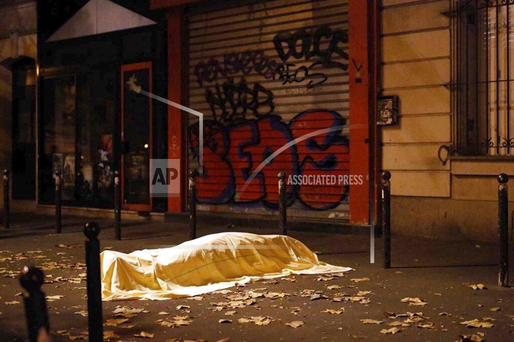 Jerome Delay FILE - In this Friday Nov. 13, 2015 file photo a victim under a blanket lays dead outside the Bataclan theater in Paris. (AP Photo/Jerome Delay, File)