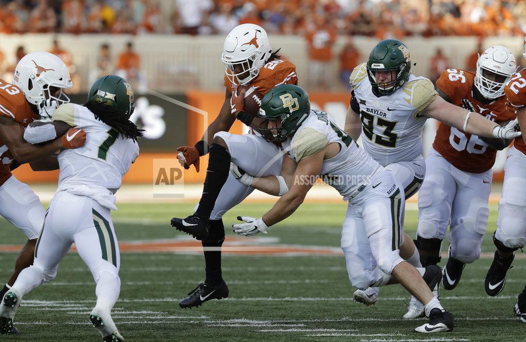 Eric Gay Texas running back Keaontay Ingram (26) is hit by Baylor linebacker Clay Johnston (44) during the second half of an NCAA college football game, Saturday, Oct. 13, 2018, in Austin, Texas. (AP Photo/Eric Gay)