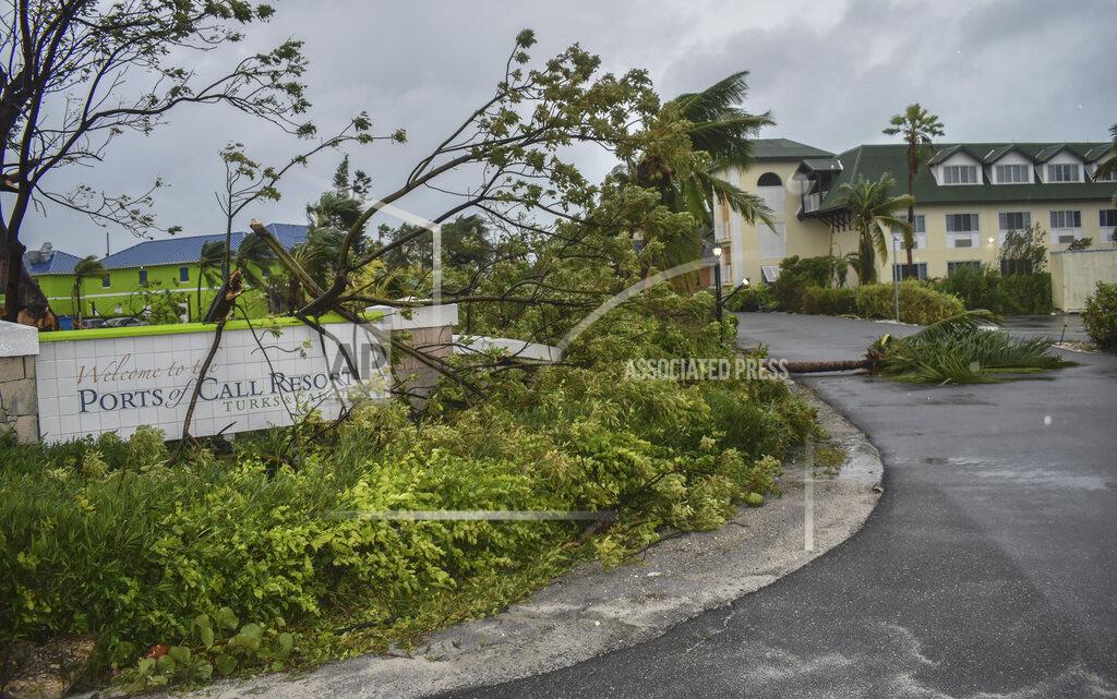 Vivian Tyson Fallen trees lay over the Ports of Call Resort entrance after the passage of Hurricane Fiona in Providenciales, Turks and Caicos Islands, Tuesday, Sept. 20, 2022. (AP Photo/Vivian Tyson)