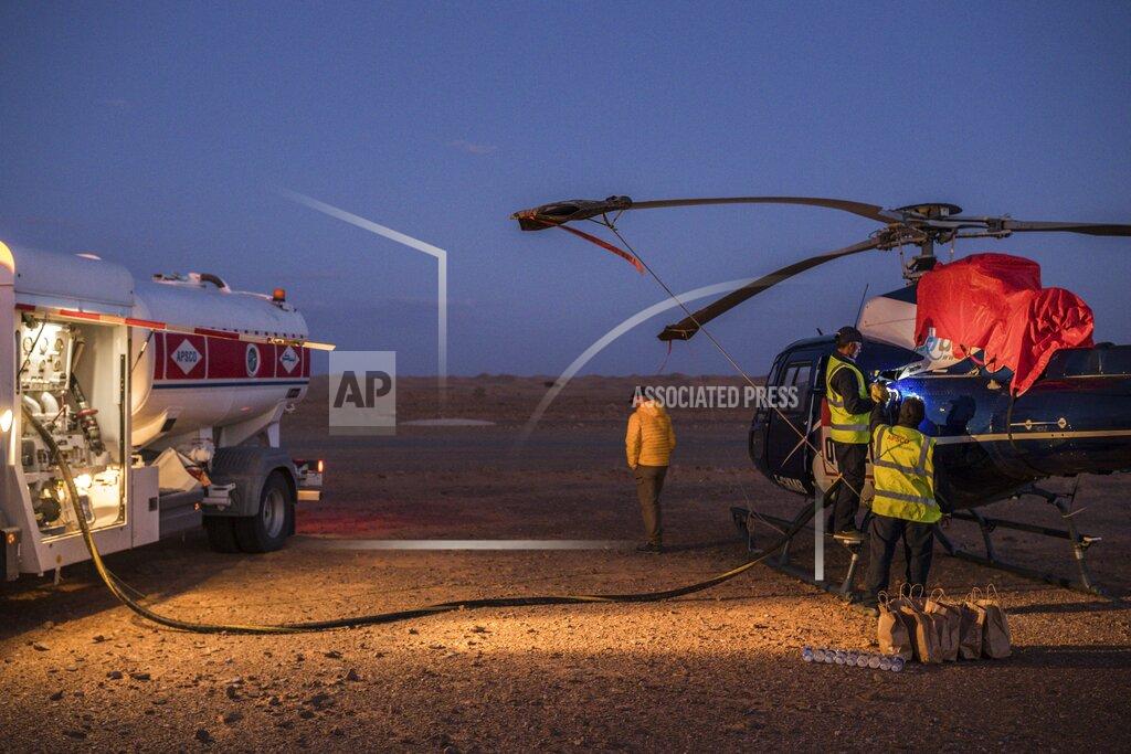 Bernat Armangue In this Sunday, Jan. 12, 2020 photo, APSCO employees fill a tank of a Dakar helicopter at the end of stage seven in Wadi Al Dawasir, Saudi Arabia. Formerly known as the Paris-Dakar Rally, the race was created by Thierry Sabine after he got lost in the Libyan desert in 1977. Until 2008, the rallies raced across Africa, but threats in Mauritania led organizers to cancel that year's event and move it to South America. It has now shifted to Saudi Arabia. The race started on Jan. 5 with 560 drivers and co-drivers, some on motorbikes, others in cars or in trucks. Only 41 are taking part in the Original category. (AP Photo/Bernat Armangue)