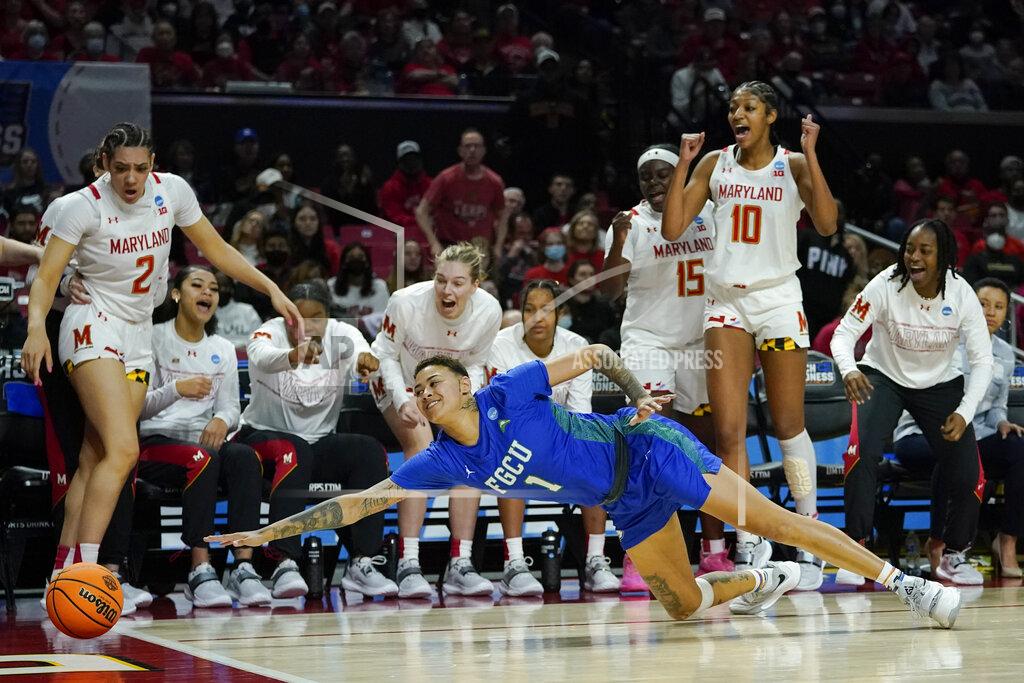 Julio Cortez Florida Gulf Coast guard Kierstan Bell (1) dives to try to keep the ball in bounds as the Maryland bench reacts during the second half of a college basketball game in the second round of the NCAA tournament, Sunday, March 20, 2022, in College Park, Md. Maryland won 89-65. (AP Photo/Julio Cortez)