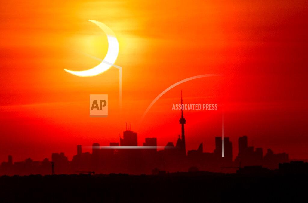 Frank Gunn An annular solar eclipse rises over the skyline of Toronto on Thursday, June 10, 2021. (Frank Gunn/The Canadian Press via AP)