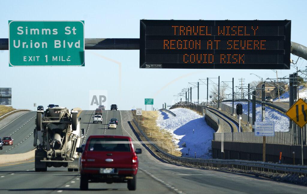 David Zalubowski An electronic road sign warns motorists on eastbound Sixth Avenue of the spiraling increase in coronavirus cases and the heightened alert in place for residents early Monday, Nov. 30, 2020, in Lakewood, Colo. (AP Photo/David Zalubowski)