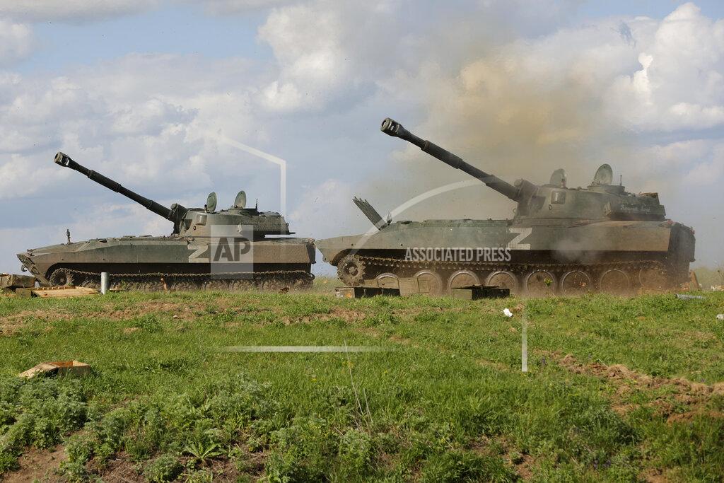 Alexei Alexandrov Self-propelled artillery vehicles 'Gvozdika' ('Carnation') of Donetsk People's Republic militia fire towards Ukrainian army position, near the town of Yasynuvataya, outside Donetsk, in territory under the government of the Donetsk People's Republic, eastern Ukraine, Friday, May 20, 2022. (AP Photo/Alexei Alexandrov)