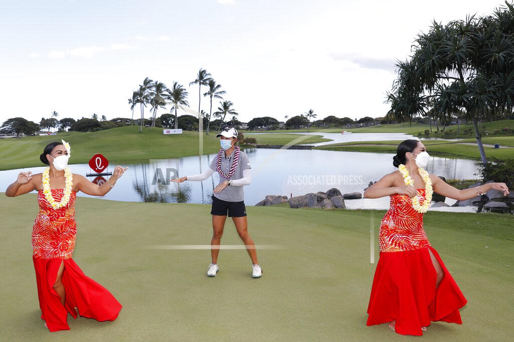 Marco Garcia Lydia Ko, of New Zealand, center, performs a hula dance after winning the Lotte Championship golf tournament, Saturday, April 17, 2021, in Kapolei, Hawaii. (AP Photo/Marco Garcia)