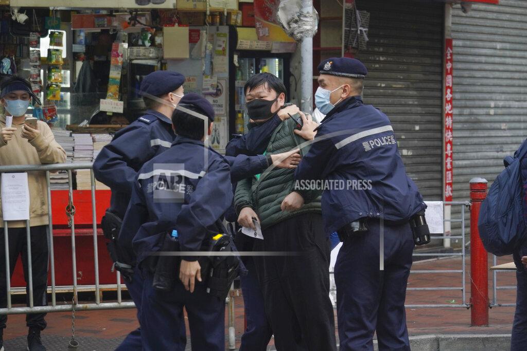 Kin Cheung A man is detained after confronting a police officer as he wants to enter the closed area in Jordan area of Hong Kong, Saturday, Jan. 23, 2021. Thousands of Hong Kong residents were locked down Saturday in an unprecedented move to contain a worsening outbreak in the city, authorities said. (AP Photo/Kin Cheung)