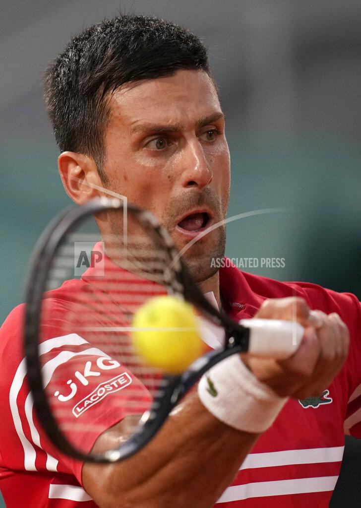Christophe Ena Serbia's Novak Djokovic plays a return to United States's Tennys Sandgren during their first round match on day three of the French Open tennis tournament at Roland Garros in Paris, France, Tuesday, June 1, 2021. (AP Photo/Christophe Ena)