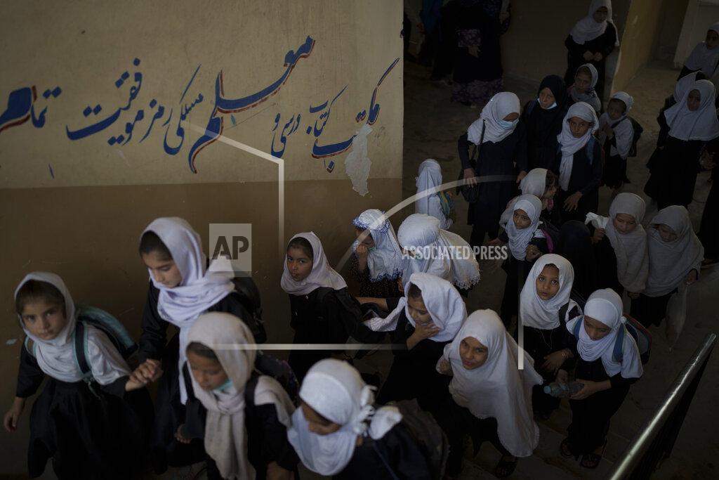 Felipe Dana Girls walk upstairs as they enter a school before class in Kabul, Afghanistan, Sunday, Sept. 12, 2021. (AP Photo/Felipe Dana)
