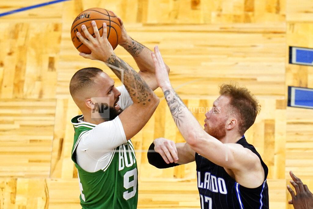 John Raoux Boston Celtics guard Evan Fournier, left, goes up for a shot against Orlando Magic forward Ignas Brazdeikis during the second half of an NBA basketball game, Wednesday, May 5, 2021, in Orlando, Fla. (AP Photo/John Raoux)