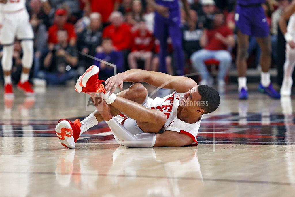 Brad Tollefson Texas Tech's Kevin McCullar (15) grabs his ankle after falling to the floor during the first half of an NCAA college basketball game against TCU, Saturday, Feb. 12, 2022, in Lubbock, Texas. (AP Photo/Brad Tollefson)