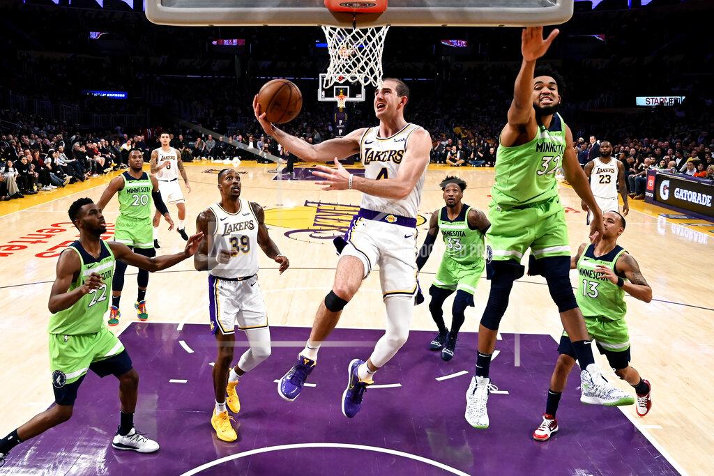 Ringo H.w. Chiu FILE - In this Dec. 8, 2019, file photo, Los Angeles Lakers' Alex Caruso (4) goes to basket under pressure from Minnesota Timberwolves' Karl-Anthony Towns (32) during the second half of an NBA basketball game in Los Angeles. Caruso was averaging 5.4 points, 1.9 rebounds and 1.8 assists in 17.8 minutes wen the hiatus began. With Avery Bradley opting out of the restart and Rajon Rondo breaking his thumb in practice this month, the 6-foot-5 Caruso should have a greater role in the Lakers’ bench during the restart. (AP Photo/Ringo H.W. Chiu, File)