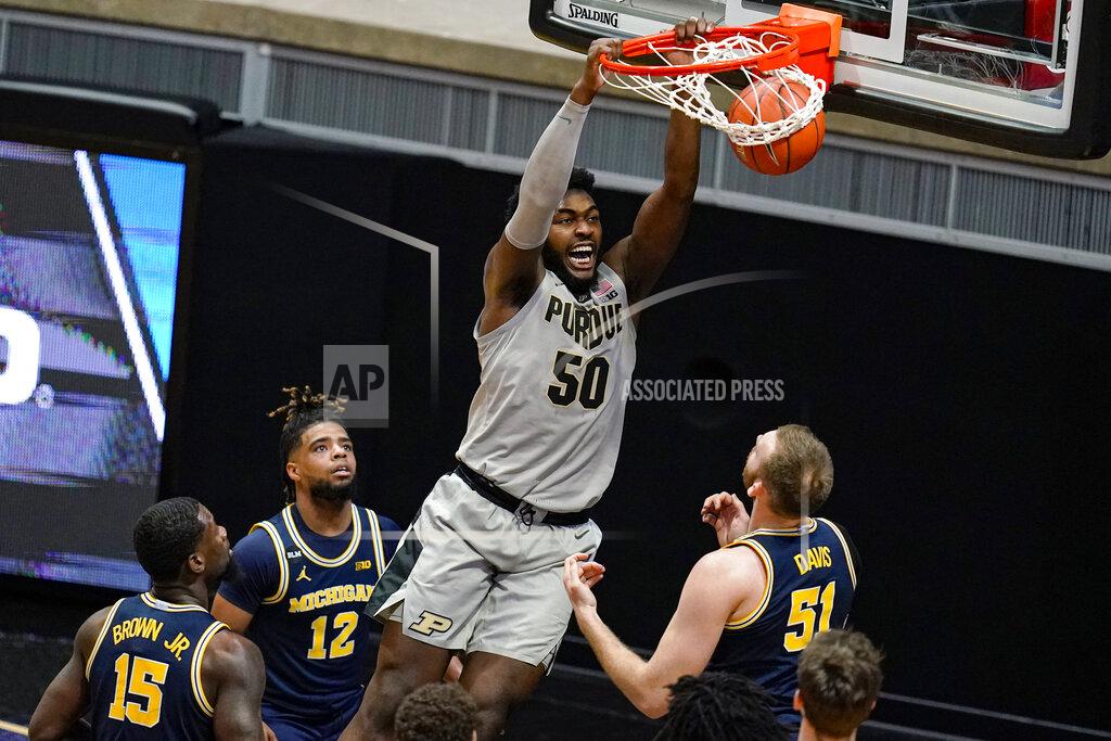 Michael Conroy Purdue forward Trevion Williams (50) dunks over Michigan forward Austin Davis (51) during the first half of an NCAA college basketball game in West Lafayette, Ind., Friday, Jan. 22, 2021. (AP Photo/Michael Conroy)