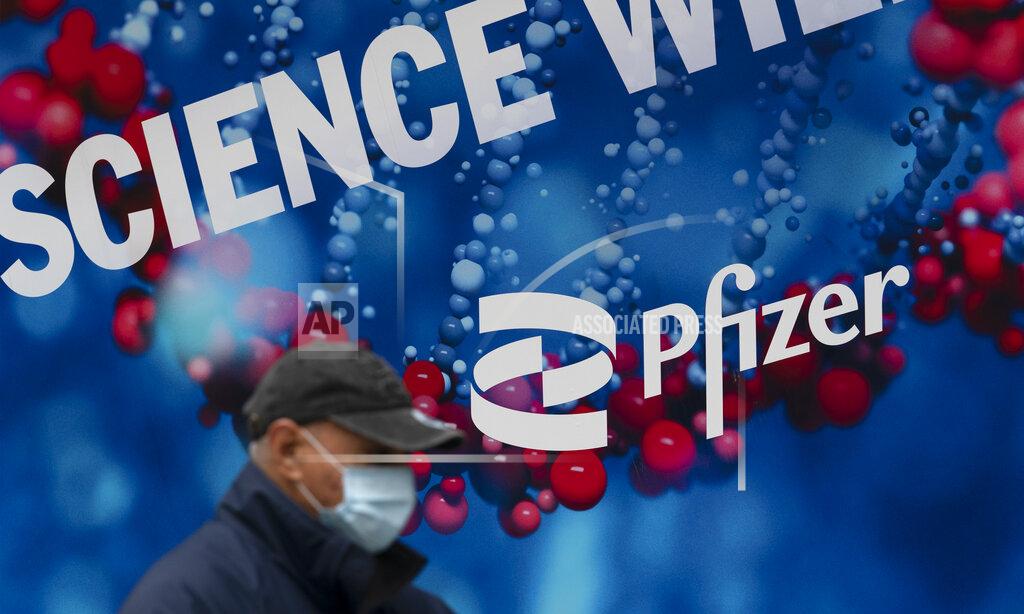 Mark Lennihan FILE - A man walks by Pfizer headquarters, Friday, Feb. 5, 2021 in New York. On Friday, May 27, 2022 The Associated Press reported on stories circulating online incorrectly claiming Pfizer received FDA approval for a new monkeypox shot the day after the U.S. purchased millions of dollars worth of vaccine for the disease. (AP Photo/Mark Lennihan)