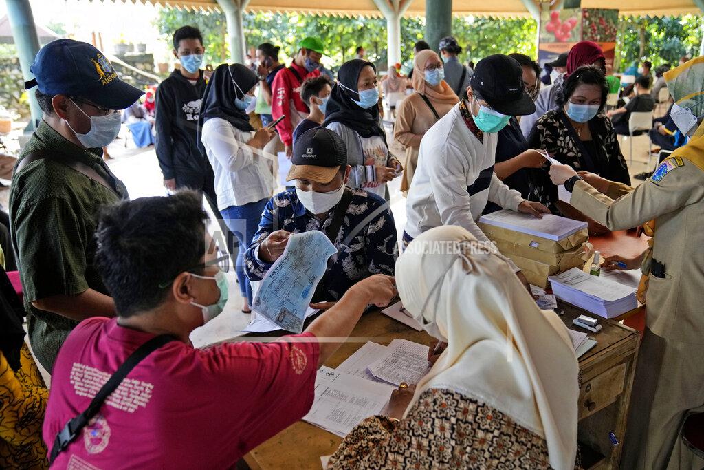 Dita Alangkara People register to receive the COVID-19 vaccine during a mass vaccination in Jakarta, Indonesia, Monday, June 21, 2021. Indonesia's president ordered authorities to speed up the country's vaccination campaign as the World Health Organization warned of the need to increase social restrictions in the country amid a fresh surge of coronavirus infections caused by worrisome variants. (AP Photo/Dita Alangkara)
