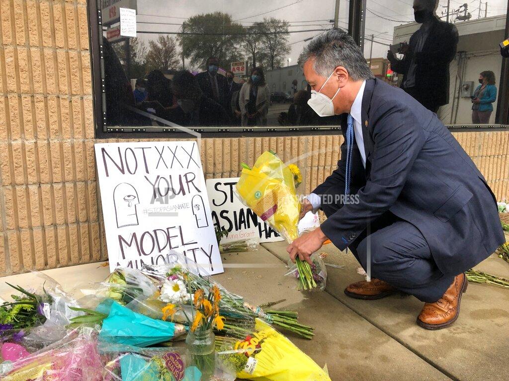 Sudhin Thanawala California Rep. Mark Takano lays flowers in front of Aromatherapy Spa in Atlanta, another shooting site, Sunday, March 28, 2021. (AP Photo/Sudhin Thanawala)