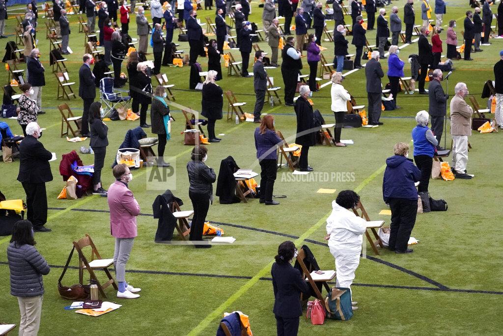 Charles Krupa Legislators stand for the Pledge of Allegiance during a New Hampshire House of Representatives legislative session held at NH Sportsplex, due to the coronavirus, Wednesday, Feb. 24, 2021, in Bedford, N.H. (AP Photo/Charles Krupa)