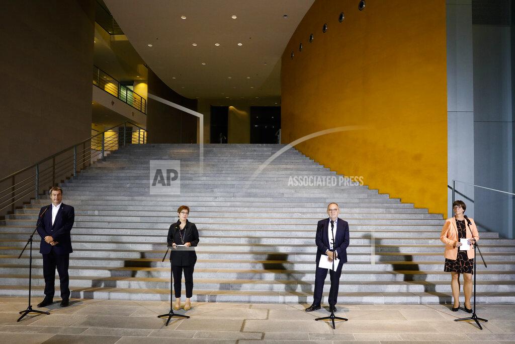 Markus Schreiber FILE - In this Aug. 25, 2020 file photo, Christian Social Union chairman and Bavarian governor Markus Soeder, Christian Democratic Union chairwoman Annegret Kramp-Karrenbauer, Social Democratic Party co-chairman Walter-Borjans and co-chairwoman Saskia Esken, from left, arrive for a news conference after a meeting with German Chancellor Angela Merkel at the chancellery in Berlin, Germany. The coronavirus pandemic is colliding with politics as Germany embarks on its vaccination drive and one of the most unpredictable election years in its post-World War II history. (AP Photo/Markus Schreiber, File)