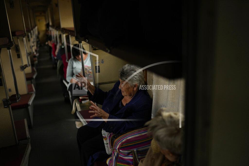 Francisco Seco Lyubov Chudnyk, right, fleeing from heavy shelling, waits aboard an evacuation train to depart Pokrovsk train station, in Pokrovsk, eastern Ukraine, Sunday, May 22, 2022. Civilians fleeing areas near the eastern front in the war in Ukraine Sunday described scenes of devastation as their towns and villages came under sustained attack from Russian forces. (AP Photo/Francisco Seco)