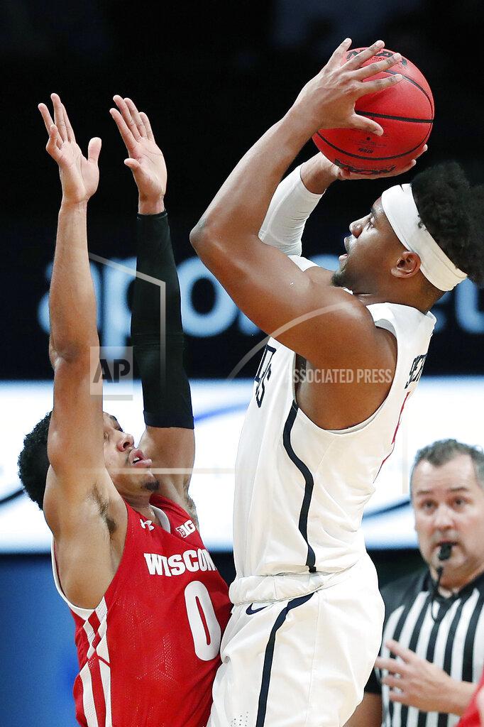 Kathy Willens Richmond guard Nick Sherod (5) shoots over Wisconsin guard D'Mitrik Trice (0) during the first half of an NCAA college basketball game in the Legends Classic, Monday, Nov. 25, 2019, in New York. (AP Photo/Kathy Willens)