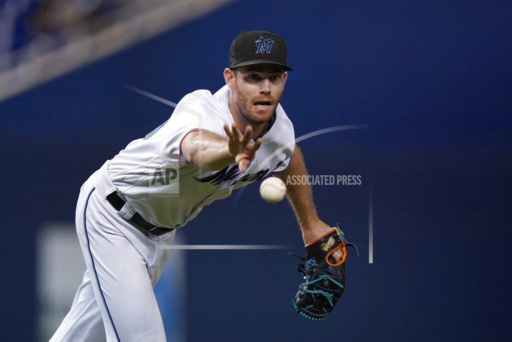 Wilfredo Lee Miami Marlins relief pitcher Anthony Bender tosses the ball to first for the out on New York Mets' Jeff McNeil during the 10th inning of a baseball game Wednesday, Sept. 8, 2021, in Miami. (AP Photo/Wilfredo Lee)