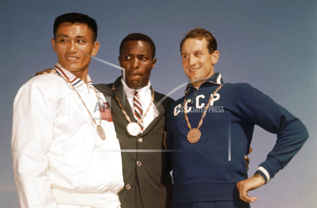 Anonymous FILE - In this Sept. 6, 1960, file photo, the top three finishers in the decathlon of the 1960 Rome Summer Olympics stand on the podium while wearing their medals at Olympic Stadium in Rome. Rafer Johnson, center, won the gold; Taiwan's Yang Chuan, left, the silver; and Russia's Vasili Kuznetsov the bronze. Rafer Johnson, who won the decathlon at the 1960 Rome Olympics and helped subdue Robert F. Kennedy's assassin in 1968, died Wednesday, Dec. 2, 2020. He was 86. He died at his home in the Sherman Oaks section of Los Angeles, according to family friend Michael Roth.(AP Photo/File)