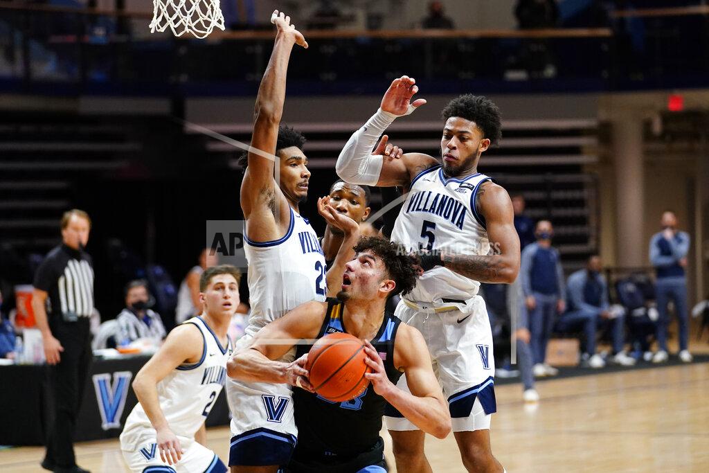 Matt Slocum Marquette's Dawson Garcia, center, tries to get a shot past Villanova's Jermaine Samuels, left, and Justin Moore during the second half of an NCAA college basketball game, Wednesday, Feb. 10, 2021, in Villanova, Pa. (AP Photo/Matt Slocum)