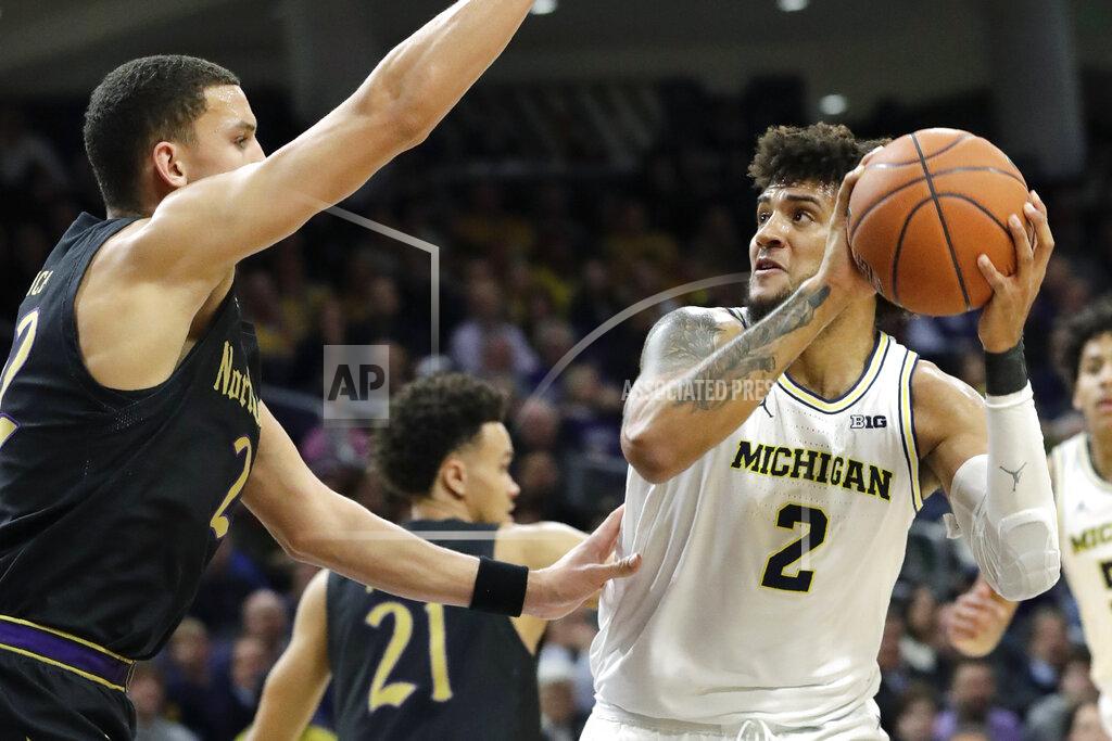 Nam Y. Huh Michigan forward Isaiah Livers, right, looks to the basket against Northwestern forward Pete Nance during the first half of an NCAA college basketball game in Evanston, Ill., Wednesday, Feb. 12, 2020. (AP Photo/Nam Y. Huh)