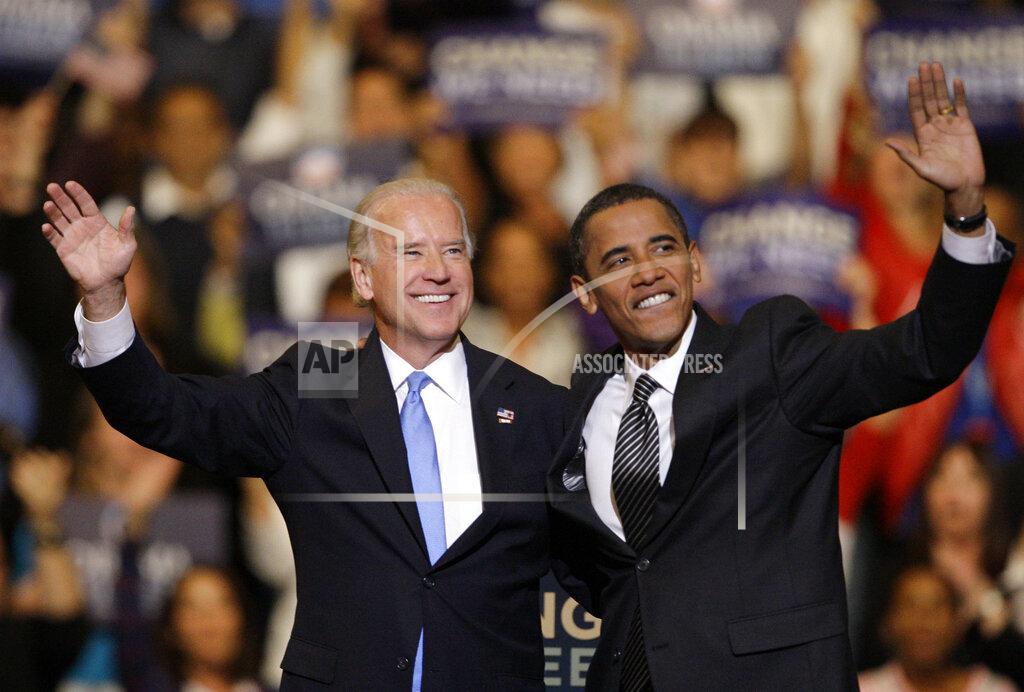 Lynne Sladky FILE - In this Oct. 29, 2008, file photo Vice presidential candidate Joe Biden, D-Del., left, and Democratic presidential candidate Sen. Barack Obama, D-Ill., right, wave during a rally at the Bank Atlantic Center in Sunrise, Fla. (AP Photo/Lynne Sladky, File)