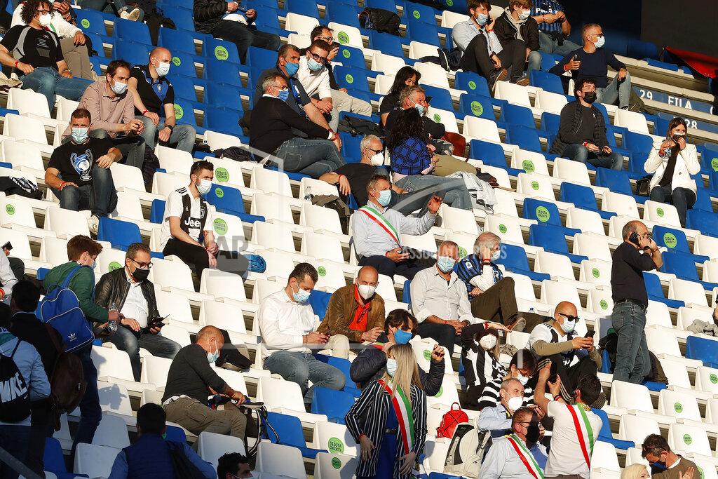 Antonio Calanni Atalanta fans wearing face protection masks are seen before the Italian Cup soccer final match between Atalanta and Juventus at the Mapei Stadium in Reggio Emilia, Italy, Wednesday, May 19, 2021. (AP Photo/Antonio Calanni)