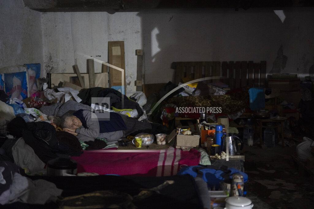 Leo Correa A woman lies on a bed inside a basement used as a bomb shelter during Russian attacks in Severodonetsk, Luhansk region, Ukraine, Friday, May 13, 2022. (AP Photo/Leo Correa)