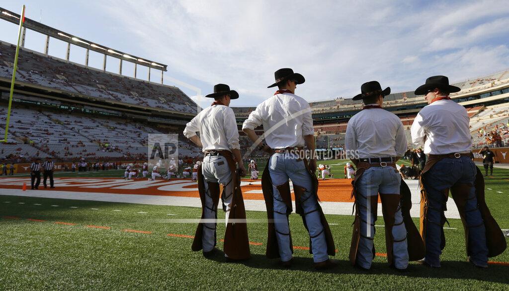 Eric Gay FILE - In this Aug. 30, 2014, file photo, members of The Texas Cowboys stand on the sidelines before an NCAA college football game between Texas and North Texas in Austin, Texas. On Wednesday, March 28, 2019, The University of Texas has suspended the spirit team for six years after an investigation found that a student death could have been avoided if a team retreat marked by hazing had been better managed. (AP Photo/Eric Gay, File)