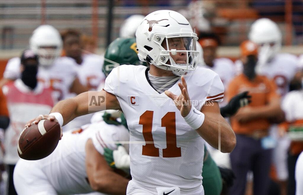 FILE - In this Oct. 24, 2020, file photo, Texas' Sam Ehlinger looks to pass against Baylor during the first half of an NCAA college football game in Austin, Texas. Who would make a college football Super League? Think big-brand schools with large fanbases and a history of success ... such as Texas. (AP Photo/Chuck Burton, File)