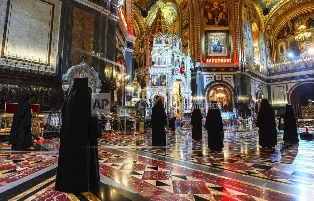 Russian Orthodox Church nuns, observe social distancing guidelines as they attend the church's main service celebrating Orthodox Easter at Moscow's Christ the Savior Cathedral in Moscow, Russia, early Sunday, April 19, 2020. Orthodox priests in much of Europe held Easter services in churches empty of parishioners because of restrictions imposed to block the spread of coronavirus. (Oleg Varov, Russian Orthodox Church Press Service via AP)