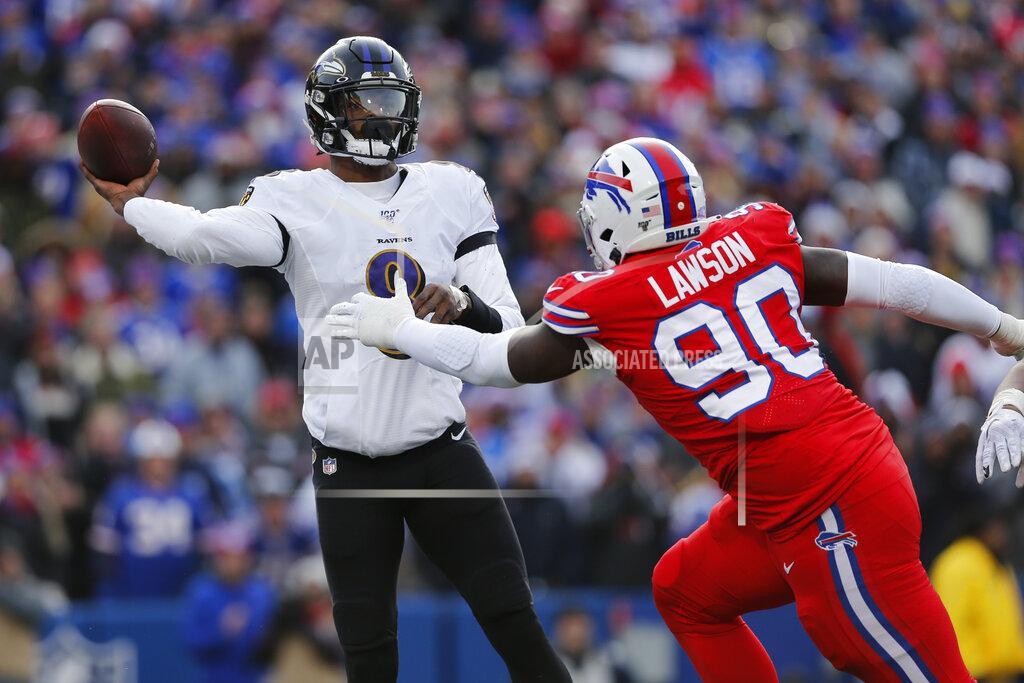 Baltimore Ravens quarterback Lamar Jackson (8) gets off a pass under pressure by Buffalo Bills defensive end Shaq Lawson (90) during the first half of an NFL football game in Orchard Park, N.Y., Sunday, Dec. 8, 2019. (AP Photo/John Munson)