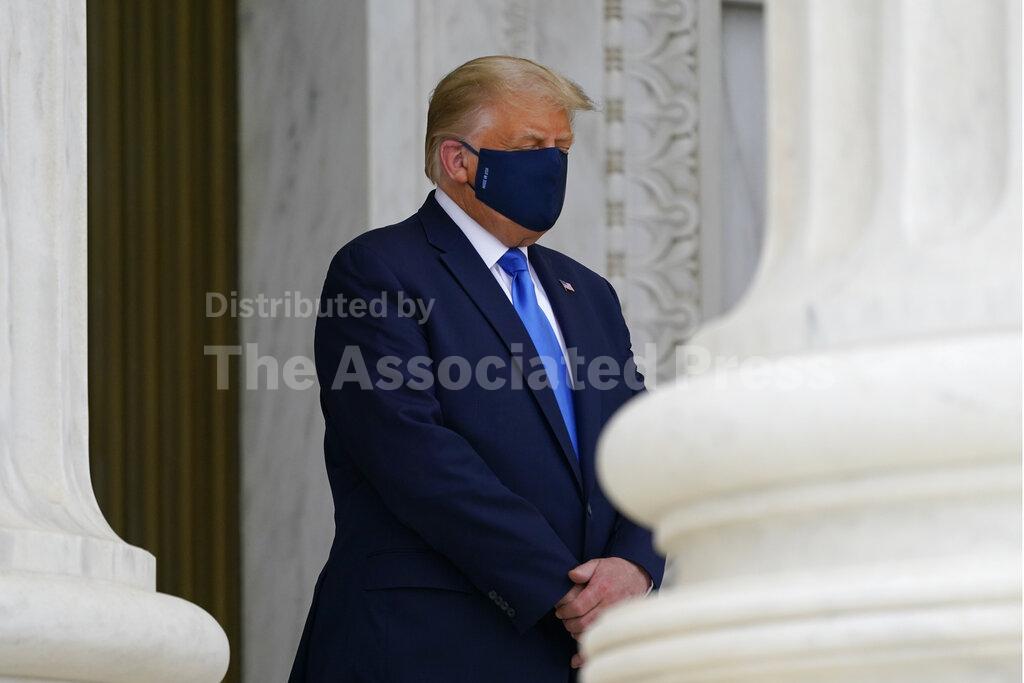 President Donald Trump pays respects as Justice Ruth Bader Ginsburg lies in repose under the Portico at the top of the front steps of the U.S. Supreme Court building on Thursday, Sept. 24 2020, in Washington. Ginsburg, 87, died of cancer on Sept. 18. (AP Photo/Alex Brandon, Pool)
