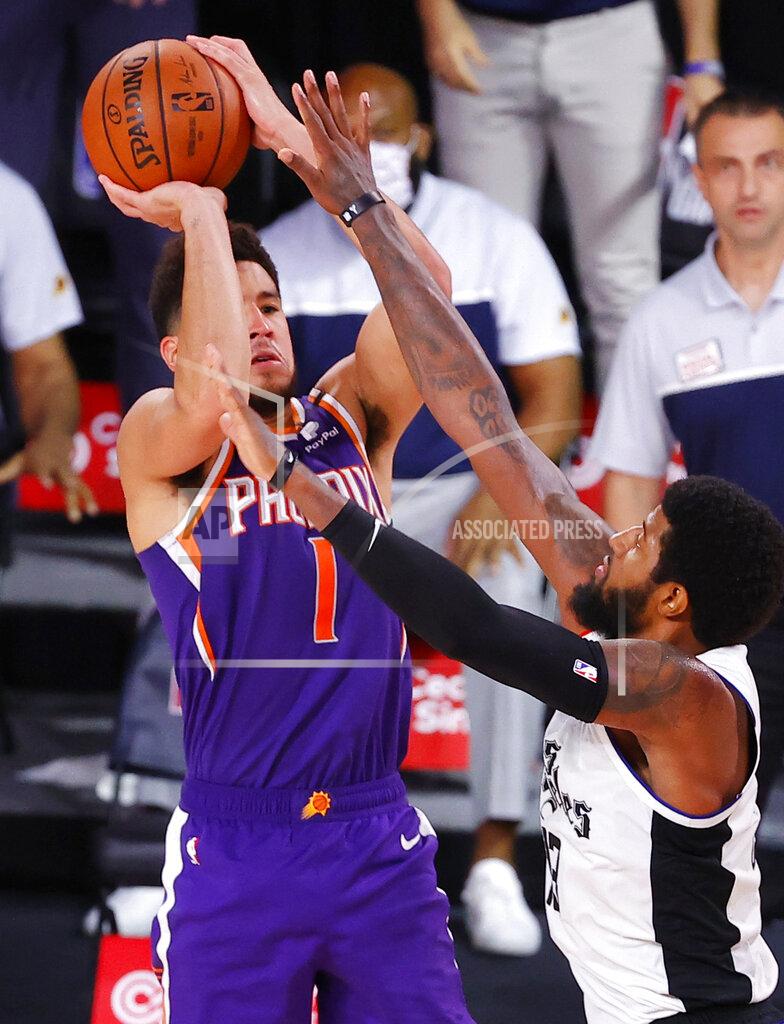 Kevin C. Cox Phoenix Suns' Devin Booker shoots the game-winning basket over Los Angeles Clippers' Paul George in an NBA basketball game Tuesday, Aug. 4, 2020, in Lake Buena Vista, Fla. (Kevin C. Cox/Pool Photo via AP)