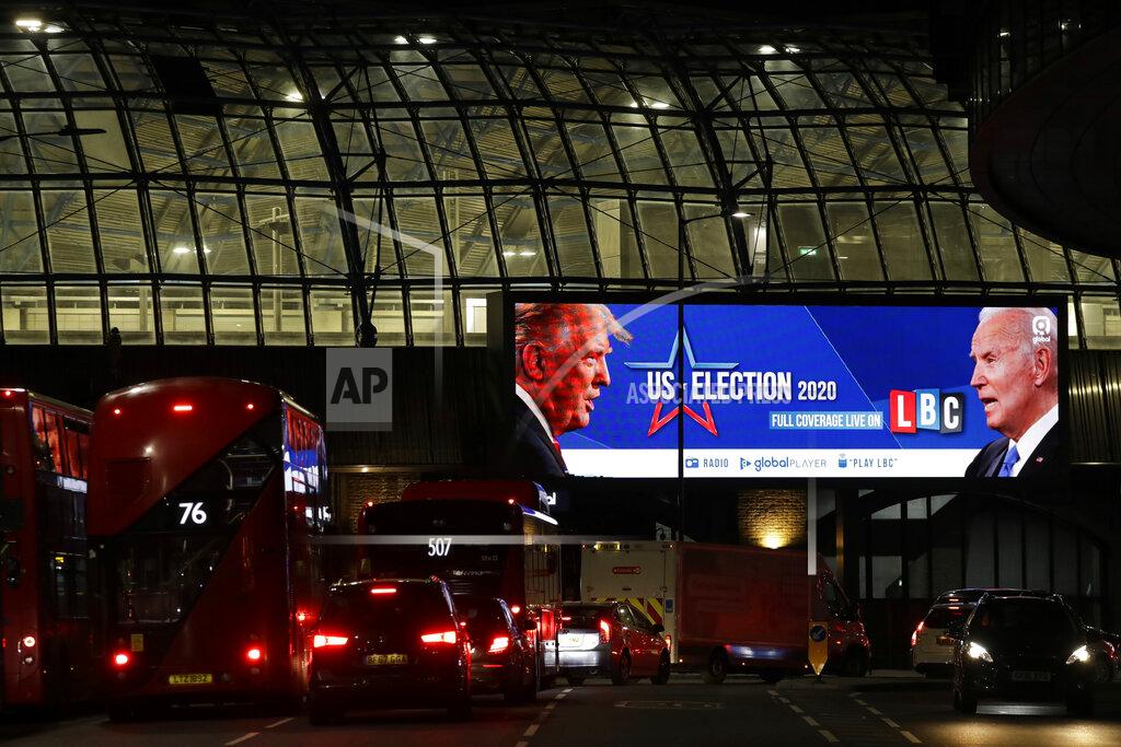 Matt Dunham FILE - In this Nov. 2, 2020 file photo an advert screen in London, promotes the radio coverage of LBC (London Broadcasting Company) ahead of Tuesday's U.S. presidential election. If you're the leader of an increasingly isolated country, what's better — to keep an unreliable friend or gain a dependable critic? That's the dilemma facing British Prime Minister Boris Johnson over a U.S. election taking place weeks before the U.K. makes an economic split from the European Union at year's end and seeks new trade and diplomatic partners. (AP Photo/Matt Dunham, File)