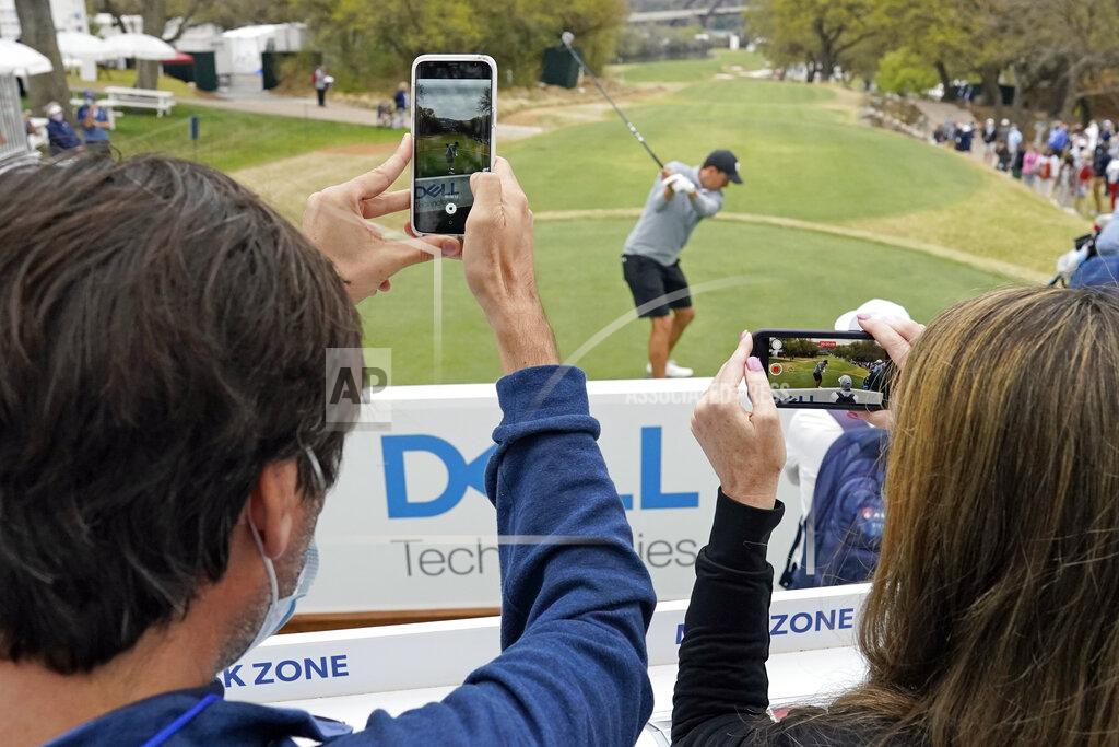 David J. Phillip Fans film Jordan Spieth as he tees off on the 12th hole during a practice round for the Dell Technologies Match Play Championship golf tournament Monday, March 22, 2021, in Austin, Texas. (AP Photo/David J. Phillip)