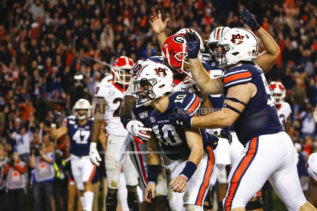 Butch Dill Auburn quarterback Bo Nix (10) celebrates after scoring a touchdown during the second half of an NCAA college football game against Georgia, Saturday, Nov. 16, 2019, in Auburn, Ala. (AP Photo/Butch Dill)