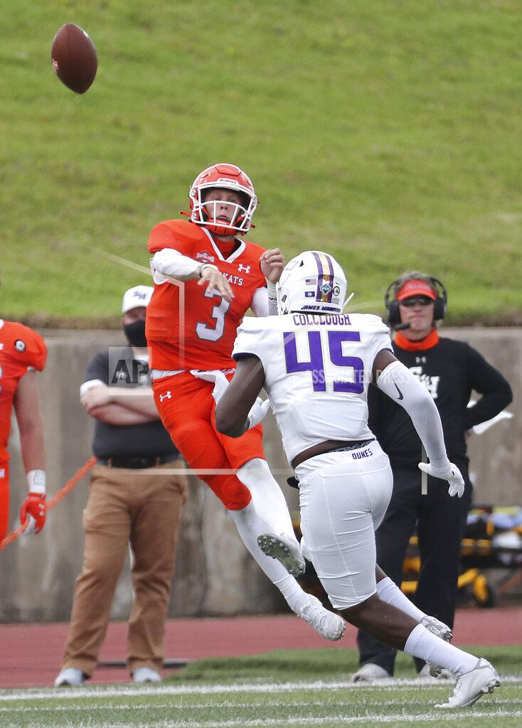 Brett Coomer Sam Houston State quarterback Eric Schmid (3) gets off a pass over James Madison defensive lineman Antonio Colclough (45) during the third quarter of a semifinal game in the NCAA college football FCS playoffs, Saturday, May 8, 2021, in Huntsville, Texas. Sam Houston came from behind to edge James Madison 38-35, for a berth in the FCS national championship game. (Brett Coomer/Houston Chronicle via AP)