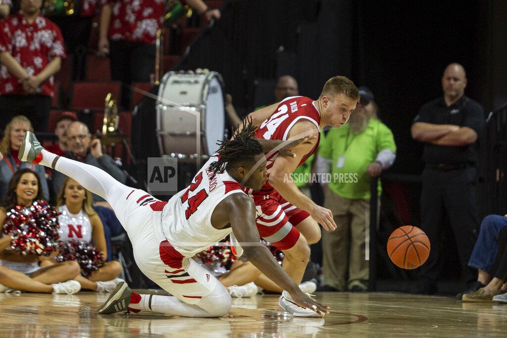 John Peterson Wisconsin guard Brad Davison (34) and Nebraska forward Yvan Ouedraogo (24) scramble for a loose ball during the first half of an NCAA college basketball game in Lincoln, Neb., Saturday, Feb. 15, 2020. (AP Photo/John Peterson)