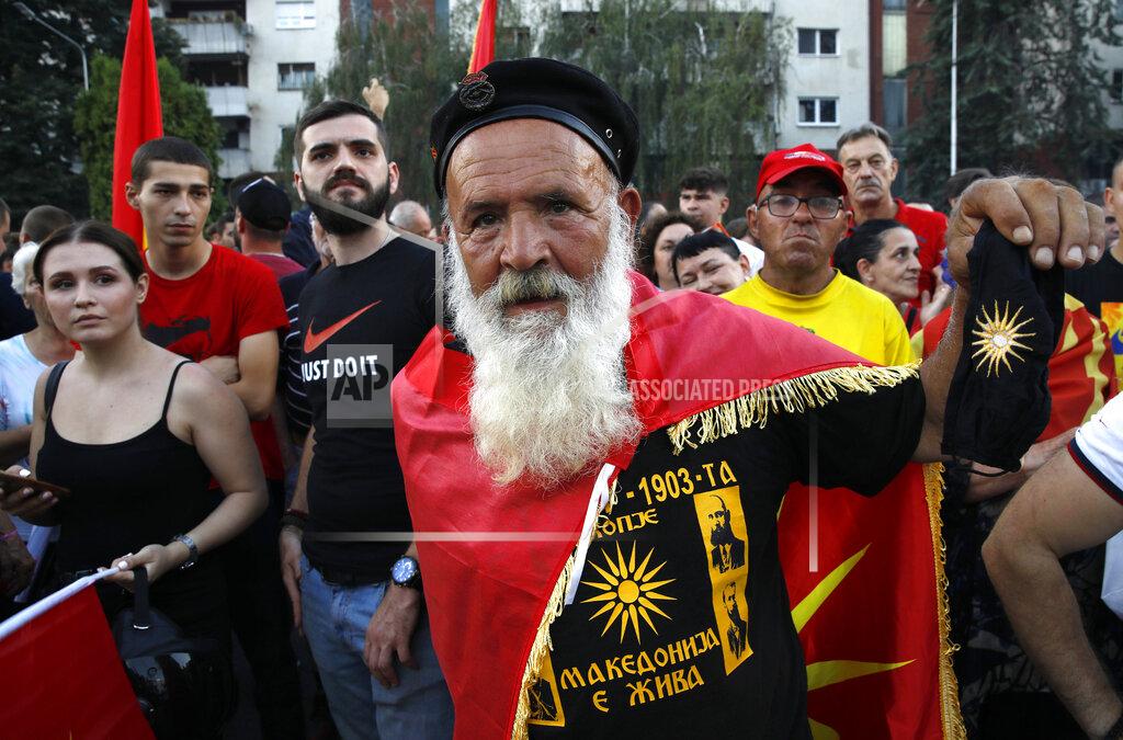 Boris Grdanoski A protester wearing a shirt, reading in Macedonian "Macedonia is alive" attends a protest in front of the government building in Skopje, North Macedonia, on Saturday, July 2, 2022. Tens of thousands of people have gathered late on Saturday in North Macedonia's capital Skopje to protest the latest French presidency proposal on solving bilateral disputes with Bulgaria that gave directions for small Balkan country to open membership talks with the European Union. (AP Photo/Boris Grdanoski)