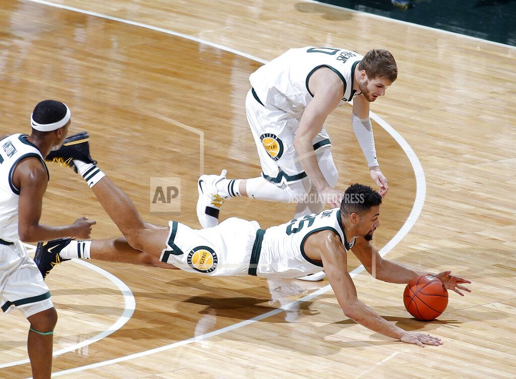 Al Goldis Michigan State's Kenny Goins, bottom, and Kyle Ahrens, top, dive for the ball against Maryland during the first half of an NCAA college basketball game, Monday, Jan. 21, 2019, in East Lansing, Mich. (AP Photo/Al Goldis)