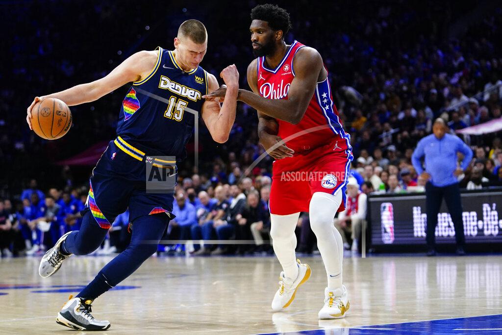 Matt Slocum Denver Nuggets' Nikola Jokic, left, tries to get past Philadelphia 76ers' Joel Embiid during the first half of an NBA basketball game, Monday, March 14, 2022, in Philadelphia. (AP Photo/Matt Slocum)