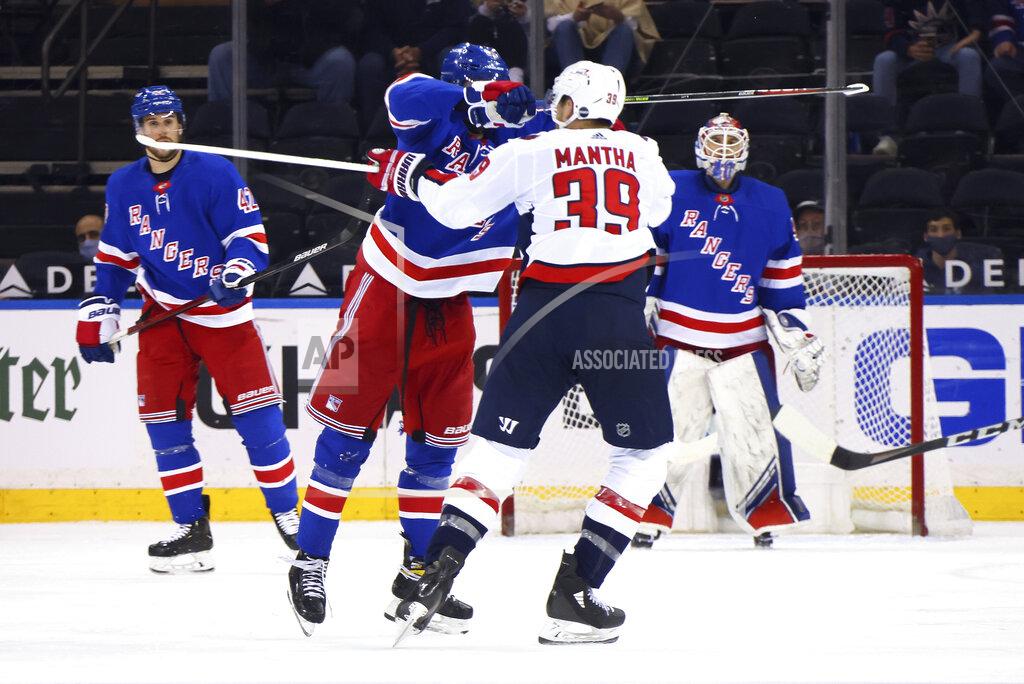 Bruce Bennett New York Rangers' Pavel Buchnevich (89) hits Washington Capitals' Anthony Mantha (39) with his stick during the second period of an NHL hockey game Wednesday, May 5, 2021, in New York. Buchnevich was penalized for high-sticking. (Bruce Bennett/Pool Photo via AP)