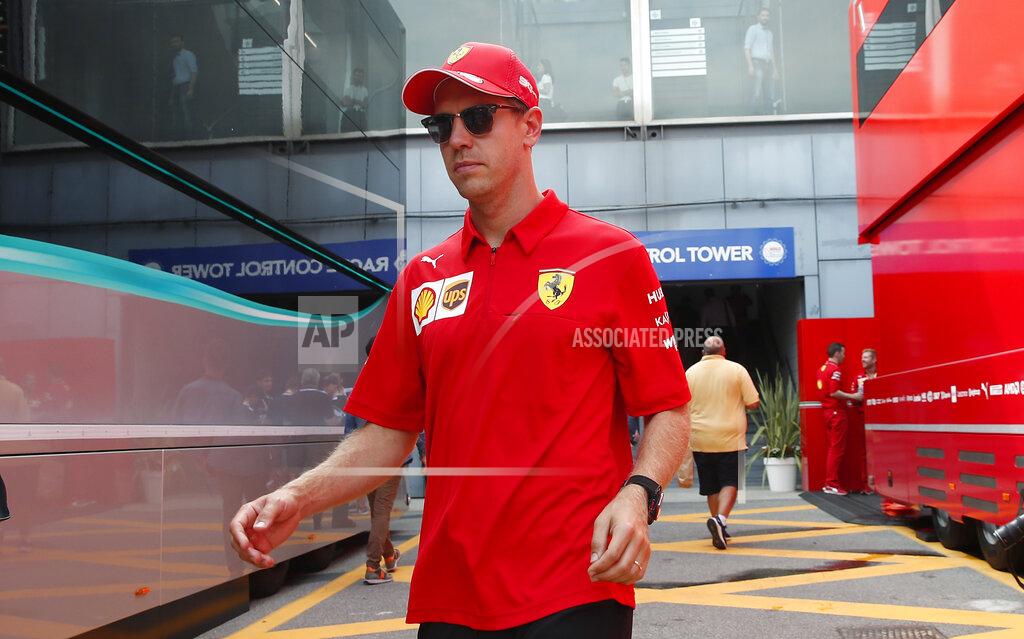 Antonio Calanni Ferrari driver Sebastian Vettel, of Germany, walks in the paddock, at the Monza racetrack, in Monza, Italy, Thursday, Sept. 5, 2019.The Formula one race will be held on Sunday. (AP Photo/Antonio Calanni)