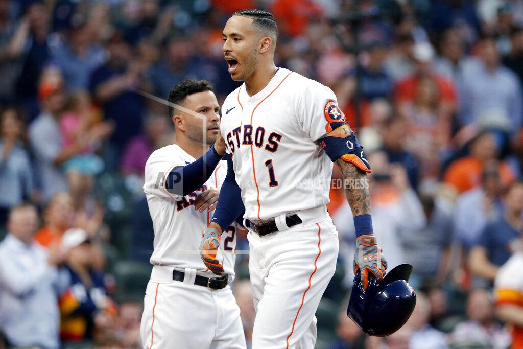 Michael Wyke Houston Astros' Jose Altuve, left, pats Carlos Correa (1) as they celebrate Correa's home run during the second inning of a baseball game against the Oakland Athletics on Thursday, April 8, 2021, in Houston. (AP Photo/Michael Wyke)