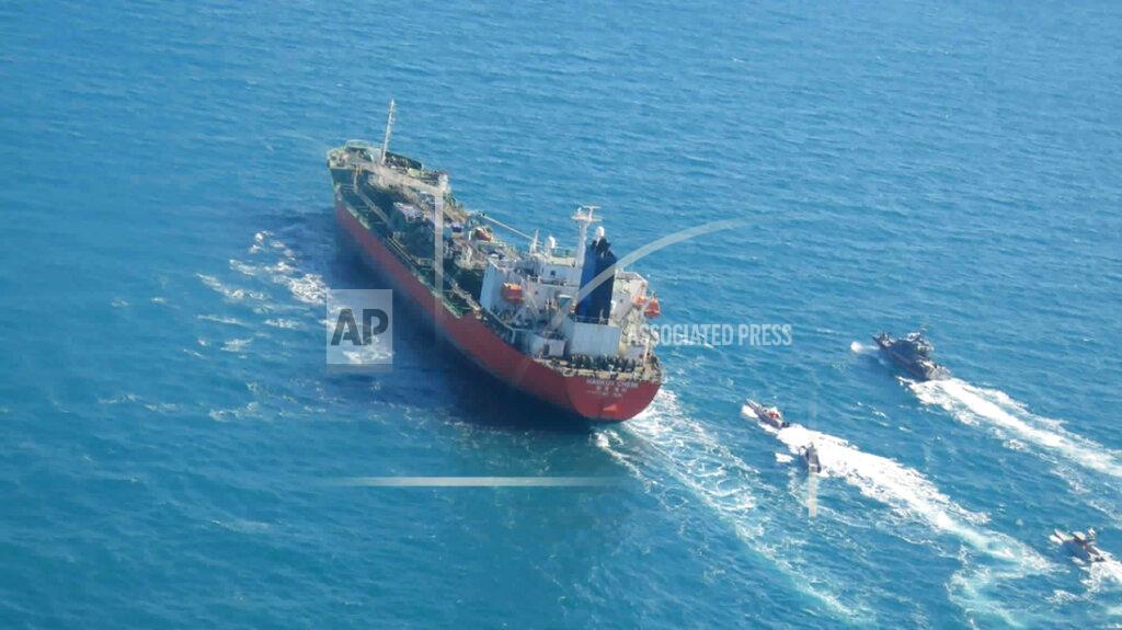Uncredited In this photo released Monday, Jan. 4, 2021, by Tasnim News Agency, a seized South Korean-flagged tanker is escorted by Iranian Revolutionary Guard boats on the Persian Gulf. Iranian state television acknowledged that Tehran seized the oil tanker in the Strait of Hormuz. The report on Monday alleged the MT Hankuk Chemi had been stopped by Iranian authorities over alleged “oil pollution” in the Persian Gulf and the strait. (Tasnim News Agency via AP)
