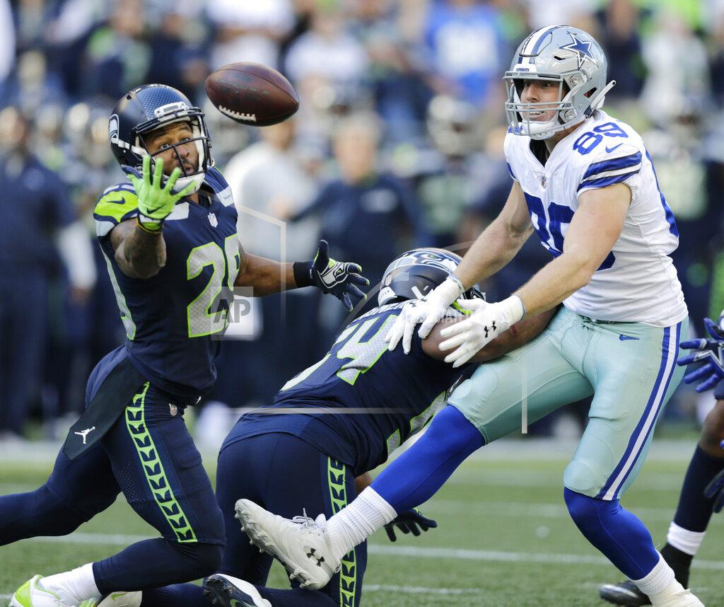 John Froschauer FILE - In this Sept. 23, 2018, file photo, Seattle Seahawks free safety Earl Thomas, left, reaches for a pass he intercepted that was intended for Dallas Cowboys tight end Blake Jarwin, right, during the second half of an NFL football game in Seattle. The pick was Thomas' second of the game. Thomas, whom Cowboys owner Jerry Jones has coveted for years, should become a leader in the Cowboys' secondary and locker room, and will never give less than his all. (AP Photo/John Froschauer, File)