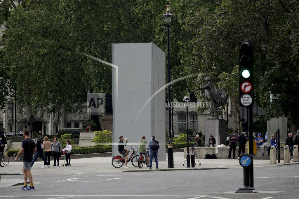 Matt Dunham A protective screen put up late Thursday encloses the statue of Britain's World War II Prime Minister Winston Churchill ahead of expected rival demonstrations by anti-racism and far-right protesters in London, Friday, June 12, 2020. Last Sunday the statue was daubed with the words "was a racist" during a protest against racism and police violence after the May 25 death of George Floyd, a black man who died after a white Minneapolis U.S. police officer pressed a knee to his neck. (AP Photo/Matt Dunham)